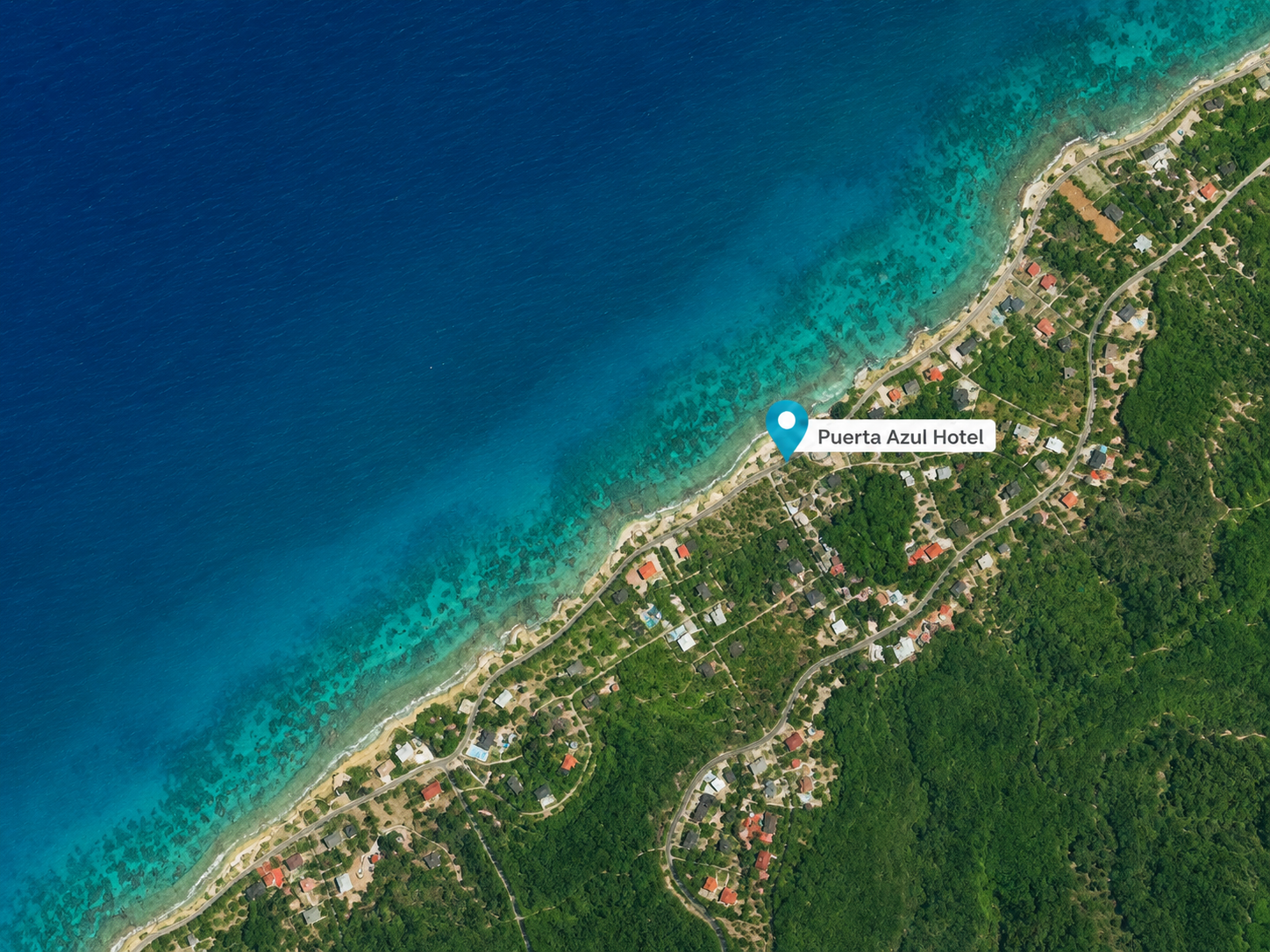 Satellite map of Sandy Bay, Roatán, showing three snorkel sites a short paddle from Puerta Azul Boutique Hotel: Spooky Channel, Uncle Jim's Pool, and Dylan's Spot.
