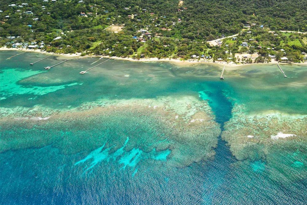 Spooky Channel Aerial View Roatan Aerial view of Spooky Channel in Sandy Bay, Roatan, showing the deep blue canyon cutting through the coral reef.